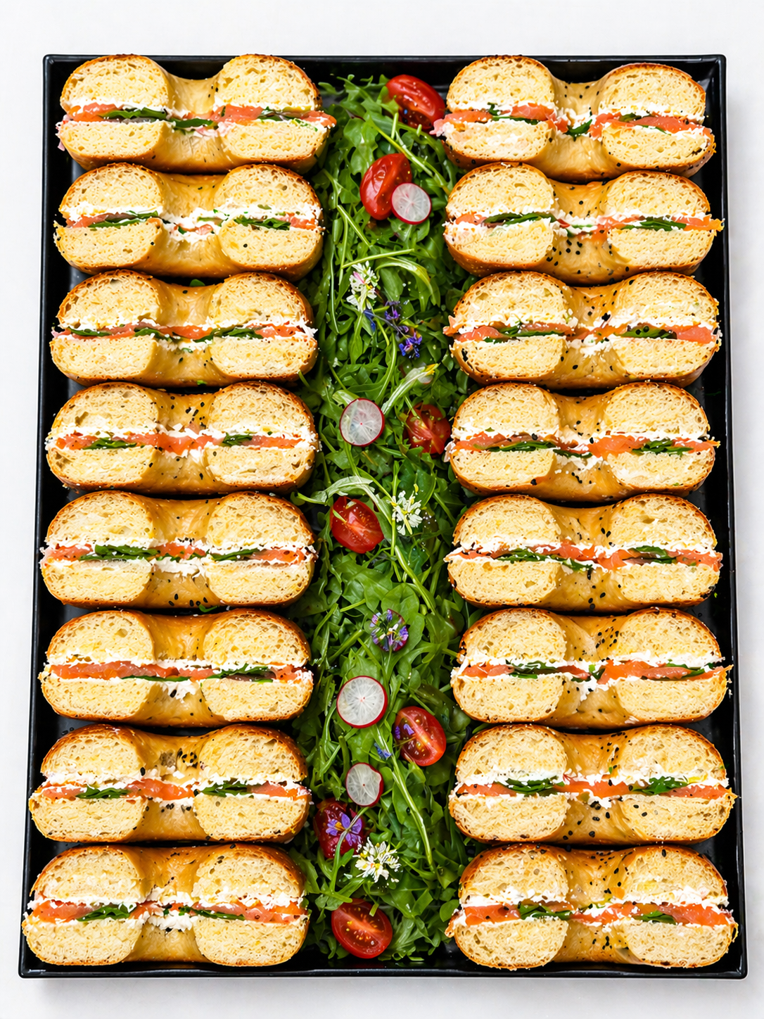 Smoked salmon bagel platters with lemon cream cheese and arugula
